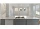 Bright kitchen features gray cabinets, stainless sink, and island with quartz countertops at 181 Longview Ave, Kissimmee, FL 34747