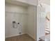 Empty laundry room with tile flooring, utility connections, and adjacent staircase at 181 Longview Ave, Kissimmee, FL 34747