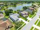 Aerial view showcasing a desirable neighborhood with homes surrounding a large lake with fountain at 2214 Westbourne Dr, Oviedo, FL 32765
