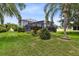 The lush backyard features a screened-in lanai, birdhouse, and well-maintained landscaping at 2214 Westbourne Dr, Oviedo, FL 32765