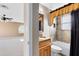 Bathroom featuring granite counters, decorative shower curtain, and tub with tile surround at 2214 Westbourne Dr, Oviedo, FL 32765