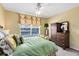 Inviting bedroom featuring a bed with green bedding and a dresser for ample storage at 2214 Westbourne Dr, Oviedo, FL 32765