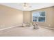 Bright bedroom with a neutral palette, featuring a ceiling fan and a view of the outdoors at 2214 Westbourne Dr, Oviedo, FL 32765