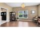 A well-lit dining room features hardwood floors, a crystal chandelier, and a view to the backyard at 2214 Westbourne Dr, Oviedo, FL 32765