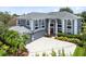 A grand two-story home boasts professional landscaping, a three car garage, and an elegant entrance at 2214 Westbourne Dr, Oviedo, FL 32765