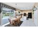Bright kitchen featuring black appliances, a center island and a dining area with a view to the backyard pool at 2214 Westbourne Dr, Oviedo, FL 32765