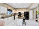 Well-lit kitchen with white cabinets, black appliances, and a center island at 2214 Westbourne Dr, Oviedo, FL 32765