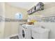 Functional laundry room with shelving, washer, dryer, and a sink at 2214 Westbourne Dr, Oviedo, FL 32765