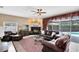 Cozy living room featuring a fireplace, leather furniture, and sliding glass doors to the pool at 2214 Westbourne Dr, Oviedo, FL 32765