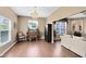 A well-lit living room features hardwood floors and neutral colors that seamlessly transition to the dining area at 2214 Westbourne Dr, Oviedo, FL 32765