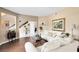 This open-concept living room shows hardwood floors, neutral paint, and leads to other living spaces at 2214 Westbourne Dr, Oviedo, FL 32765