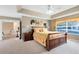 Comfortable main bedroom featuring a tray ceiling, a ceiling fan, and a sunny window at 2214 Westbourne Dr, Oviedo, FL 32765