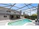 Large, screened pool with a view of the home and surrounding landscaping at 2214 Westbourne Dr, Oviedo, FL 32765