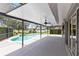 Enclosed pool area overlooking the lake with ceiling fans and ample room for lounging at 2214 Westbourne Dr, Oviedo, FL 32765