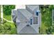 Aerial view of a roof with solar panels and lush green surrounding landscape at 245 Via Siena Ln, Lake Mary, FL 32746