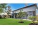 Beautiful backyard with healthy lawn and mature trees and a screened porch, perfect for outdoor living at 245 Via Siena Ln, Lake Mary, FL 32746