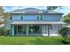 Lovely backyard with green lawn, tall trees, and a screened-in porch, complete with solar panels at 245 Via Siena Ln, Lake Mary, FL 32746