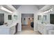 Large primary bathroom with double vanity, sinks, and mirrors with doors to the primary bedroom at 245 Via Siena Ln, Lake Mary, FL 32746
