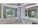 Bright bathroom with double sink, walk in shower, large garden tub, and many windows at 245 Via Siena Ln, Lake Mary, FL 32746
