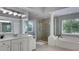 Bright bathroom with double sink, walk in shower, large garden tub, and many windows at 245 Via Siena Ln, Lake Mary, FL 32746