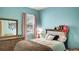 Comfortable bedroom features an accent wall, large window and dresser at 245 Via Siena Ln, Lake Mary, FL 32746