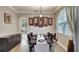 Dining room featuring a dark wood table, light-colored walls, and a large window with drapes at 245 Via Siena Ln, Lake Mary, FL 32746