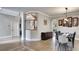 Dining room features wood floors, modern light fixture, stairs, and seating for six at 245 Via Siena Ln, Lake Mary, FL 32746