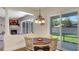 Inviting dining area features a dining table, three light chandelier, and outdoor view at 245 Via Siena Ln, Lake Mary, FL 32746