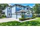 Charming two-story home featuring a three-car garage and lush landscaping for added curb appeal at 245 Via Siena Ln, Lake Mary, FL 32746