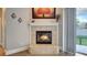 Cozy fireplace featuring decorative mantle, light-colored tile and view to the yard at 245 Via Siena Ln, Lake Mary, FL 32746