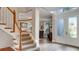 Bright foyer with hardwood floors and a staircase with wooden banister at 245 Via Siena Ln, Lake Mary, FL 32746