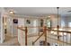 Upstairs hallway featuring wood banister and carpeted floors, perfect for privacy at 245 Via Siena Ln, Lake Mary, FL 32746