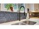 Kitchen with stainless steel sink, black faucet and patterned tile backsplash at 245 Via Siena Ln, Lake Mary, FL 32746