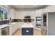 Bright kitchen with white cabinetry, stainless appliances, and contrasting dark island and backsplash at 245 Via Siena Ln, Lake Mary, FL 32746