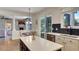 Open-concept kitchen features a large island, stainless steel appliances, and backyard views at 245 Via Siena Ln, Lake Mary, FL 32746