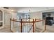 Landing features an elegant chandelier, hardwood railing, and views to the bedroom at 245 Via Siena Ln, Lake Mary, FL 32746