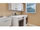 Laundry room with modern washer and dryer and sink, and bright window at 245 Via Siena Ln, Lake Mary, FL 32746