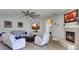 Spacious living room with a decorative fireplace, large TV, and wood laminate flooring at 245 Via Siena Ln, Lake Mary, FL 32746