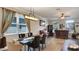 Dining and living areas featuring hardwood floors, home bar, and modern décor and neutral colors at 245 Via Siena Ln, Lake Mary, FL 32746