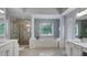 Spacious main bath with a soaking tub, walk-in shower, and dual vanities with white cabinetry at 245 Via Siena Ln, Lake Mary, FL 32746