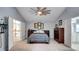 Spacious bedroom features a large bed, ensuite bathroom and double doors to landing at 245 Via Siena Ln, Lake Mary, FL 32746