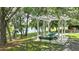 A community picnic area with a picnic table under a pergola near a lake at 245 Via Siena Ln, Lake Mary, FL 32746