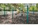 Outdoor community playground with swings, slide, climbing structures and a mulch ground cover at 245 Via Siena Ln, Lake Mary, FL 32746