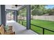Relaxing screened porch with comfortable seating overlooks the lush, green, well-maintained backyard at 245 Via Siena Ln, Lake Mary, FL 32746