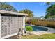 Lush backyard pool area with decorative breeze block and green landscaping at 2520 Chanute Trl, Maitland, FL 32751