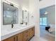 Bathroom features a double vanity, decorative mirrors, and modern glass shower at 2520 Chanute Trl, Maitland, FL 32751