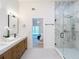 Bathroom showcasing a double vanity, open doorway to the bedroom, and glass shower at 2520 Chanute Trl, Maitland, FL 32751