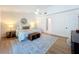 Bedroom featuring light colored walls, wood flooring, decorative rug, and ensuite bathroom at 2520 Chanute Trl, Maitland, FL 32751