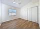 Bright bedroom features wood floors, fan, a window, and a closet for modern living at 2520 Chanute Trl, Maitland, FL 32751