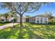 Charming single-story home featuring a lush lawn, mature tree, and brick accents, creating a welcoming curb appeal at 2520 Chanute Trl, Maitland, FL 32751